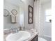 Bathroom with designer accents, white tub and granite countertops at 1752 Burrows Ave, Lakeland, FL 33811