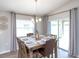 Inviting dining area with natural light, elegant lighting fixture, and comfortable seating for Gathering meals at 1752 Burrows Ave, Lakeland, FL 33811