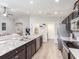 Spacious kitchen featuring dark cabinets, stainless steel appliances, granite countertops, and an open layout at 1752 Burrows Ave, Lakeland, FL 33811
