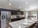 Modern kitchen with stainless steel appliances, granite countertops, and a large island with seating at 1752 Burrows Ave, Lakeland, FL 33811