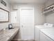 Functional laundry room with countertop space, modern appliances, and ample storage for cleaning supplies at 1752 Burrows Ave, Lakeland, FL 33811
