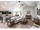 Open-concept living room with hardwood floors, comfortable seating, and an adjacent modern kitchen and dining area at 1752 Burrows Ave, Lakeland, FL 33811