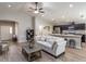 Bright and airy living room with hardwood floors, plush seating, and a view into the modern kitchen at 1752 Burrows Ave, Lakeland, FL 33811