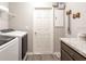 Functional laundry room with modern washer and dryer, ample counter space, and convenient storage solutions at 1758 Burrows Ave, Lakeland, FL 33811