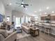 Open-concept living room featuring modern decor, ample natural light, and seamless access to the kitchen at 1758 Burrows Ave, Lakeland, FL 33811