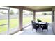 Enclosed patio with screened windows, backyard view, and outdoor dining table at 1758 Burrows Ave, Lakeland, FL 33811