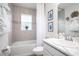 Cozy bathroom with tiled walls, a bathtub with shower, and a modern vanity at 1794 Daystar Dr, Haines City, FL 33844
