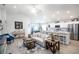 Open-concept living room seamlessly connects to the kitchen with island seating, and modern appliances at 1794 Daystar Dr, Haines City, FL 33844
