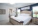 Bright and airy main bedroom with a large bed, ensuite bathroom, and stylish decor at 1794 Daystar Dr, Haines City, FL 33844