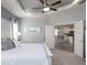 Spacious main bedroom with tray ceiling, view into kitchen, and a calming color scheme at 1867 Daystar Dr, Haines City, FL 33844