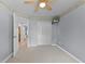 Bright bedroom with a ceiling fan, plush carpeting, and a double-door closet at 2020 Indian Trl, Lakeland, FL 33813