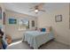 Cozy bedroom featuring a ceiling fan, carpeted floor, and a bright window with natural light at 2020 Indian Trl, Lakeland, FL 33813