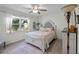 Bright bedroom featuring a decorative bed frame, ceiling fan, and windows that provide ample natural light at 2020 Indian Trl, Lakeland, FL 33813