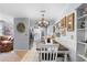 Dining area with adjacent kitchen offers a cozy setting under an elegant chandelier at 2020 Indian Trl, Lakeland, FL 33813