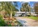 Charming single-story home with a well-manicured lawn, mature trees, and a paved driveway at 2020 Indian Trl, Lakeland, FL 33813