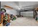 Spacious garage with storage, lawn equipment and a ceiling fan for air circulation at 2020 Indian Trl, Lakeland, FL 33813