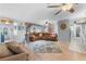Spacious open living area with wood flooring, fan and comfortable seating arrangement at 2020 Indian Trl, Lakeland, FL 33813