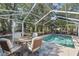Outdoor seating next to a swimming pool with screened in patio at 2020 Indian Trl, Lakeland, FL 33813