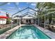 Inviting in-ground pool area with a covered lanai for shade and outdoor living at 2020 Indian Trl, Lakeland, FL 33813