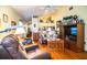 Bright living room with wooden floors, comfortable seating, and built-in display shelving at 2126 Sandy Hook, Lakeland, FL 33813