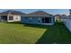 Backyard view showcasing the property's screened-in patio that provides privacy and protection from the elements at 236 Talladega Ln, Polk City, FL 33868