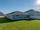 Expansive backyard featuring a well-maintained lawn and a screened-in patio, perfect for outdoor enjoyment and entertaining at 236 Talladega Ln, Polk City, FL 33868