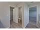 Open view into bathroom with walk-in closet, toilet room, and doorway to bedroom at 236 Talladega Ln, Polk City, FL 33868