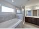 This bathroom features a soaking tub, separate shower, and double sink vanity at 236 Talladega Ln, Polk City, FL 33868