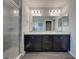 This bathroom features a separate shower and double sink vanity with wooden cabinets at 236 Talladega Ln, Polk City, FL 33868