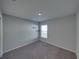 Cozy bedroom featuring gray carpet and a window at 236 Talladega Ln, Polk City, FL 33868