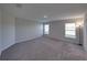 Spacious carpeted bedroom with two windows and neutral walls to match any decor at 236 Talladega Ln, Polk City, FL 33868