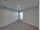 This bedroom is well lit with carpeted floors and neutral, freshly painted walls at 236 Talladega Ln, Polk City, FL 33868