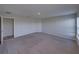 Neutral carpeted bedroom with open doorway and freshly painted neutral walls at 236 Talladega Ln, Polk City, FL 33868