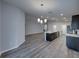 Open-concept dining room with stylish chandelier and gray wood flooring at 236 Talladega Ln, Polk City, FL 33868
