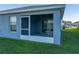 Exterior view of the screened-in back patio which offers an ideal spot to relax and entertain, enhancing the property's appeal at 236 Talladega Ln, Polk City, FL 33868