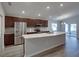 Modern kitchen with stainless steel appliances, granite countertops, and a large island perfect for entertaining at 236 Talladega Ln, Polk City, FL 33868