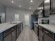 Kitchen featuring stainless steel appliances, modern countertops, and stylish cabinetry at 236 Talladega Ln, Polk City, FL 33868