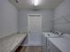 Functional laundry room with granite countertop, washer, and dryer at 236 Talladega Ln, Polk City, FL 33868