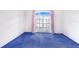 This bedroom features blue carpeting and a window with pink curtains at 2613 Sundance Cir, Mulberry, FL 33860