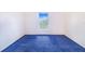 This bedroom features blue carpeting and a window offering natural light at 2613 Sundance Cir, Mulberry, FL 33860