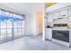 Clean, neutral kitchen with tile floors and a large window offering lots of natural light at 2613 Sundance Cir, Mulberry, FL 33860