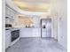 Bright kitchen with white appliances, cabinets, tile flooring, and ample counter space at 2613 Sundance Cir, Mulberry, FL 33860