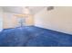 Spacious living room with plush blue carpeting, a ceiling fan, and access to outdoor space at 2613 Sundance Cir, Mulberry, FL 33860