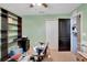 Bedroom with green walls, large window, ceiling fan, and built-in shelving at 288 Bentley Oaks Blvd, Auburndale, FL 33823