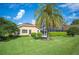 Well-manicured backyard featuring a screened-in lanai and lush landscaping at 2900 Grasslands Dr, Lakeland, FL 33803