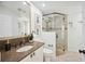 Bathroom featuring granite countertop, sink, and tiled walk-in shower with glass door at 2900 Grasslands Dr, Lakeland, FL 33803