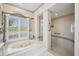 Bathroom area features a jetted tub near a window and a separate tiled shower at 2900 Grasslands Dr, Lakeland, FL 33803