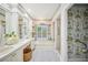 Classic bathroom with double sinks, soaking tub, and a separate shower area at 2900 Grasslands Dr, Lakeland, FL 33803