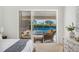 This bedroom offers a peaceful view of the pool and outdoor patio seating through sliding glass doors at 2900 Grasslands Dr, Lakeland, FL 33803