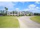 Expansive view of the clubhouse, featuring grand architecture and meticulously manicured grounds at 2900 Grasslands Dr, Lakeland, FL 33803